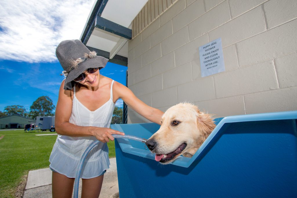 Lady bathing dog at Reflections Holiday Parks Coffs Harbour