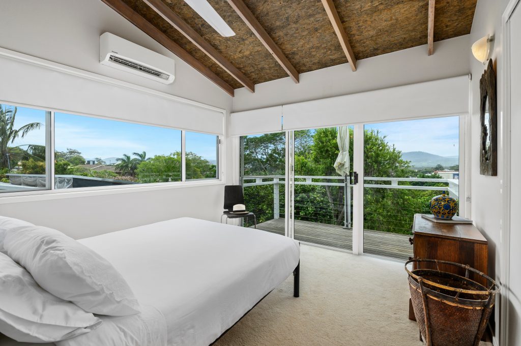 Spacious second bedroom with balcony and hinterland views