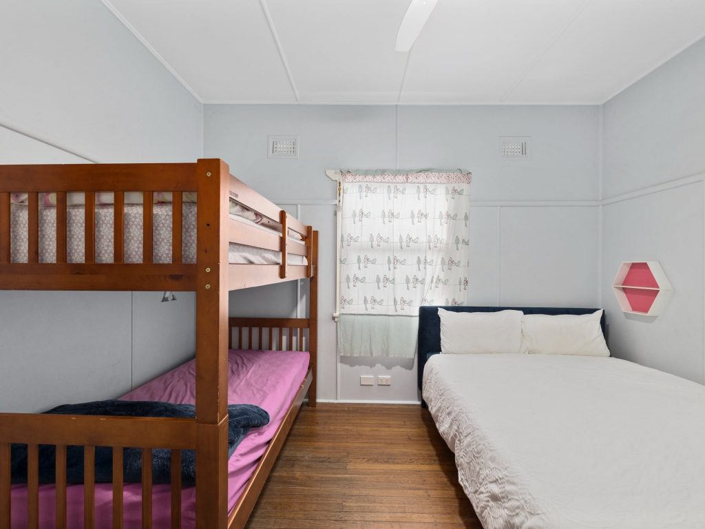 Bedroom with single bunks and queen bed