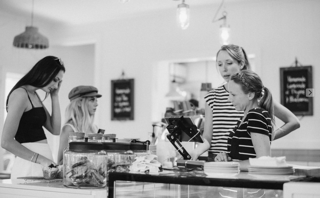 Customers served at the counter by friendly staff