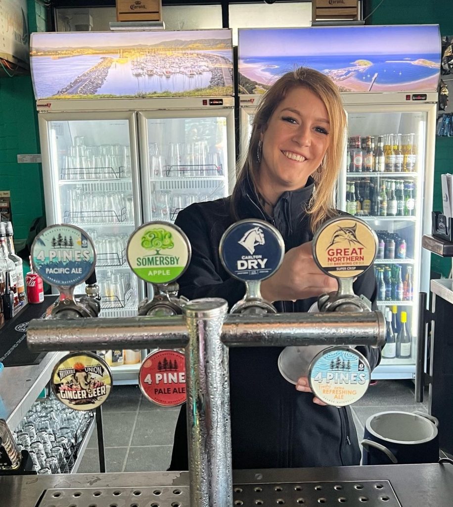 Jetty Beach Bar staff member pouring cold tap beer