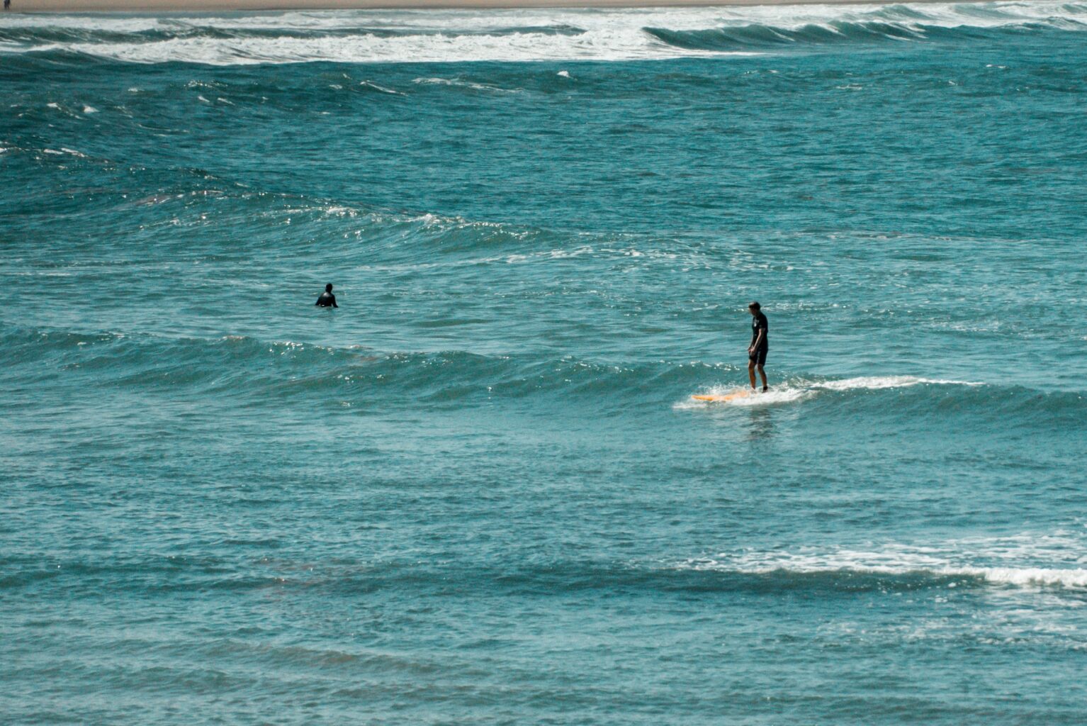 Surfer catching a wave at Arrawarra Beach
