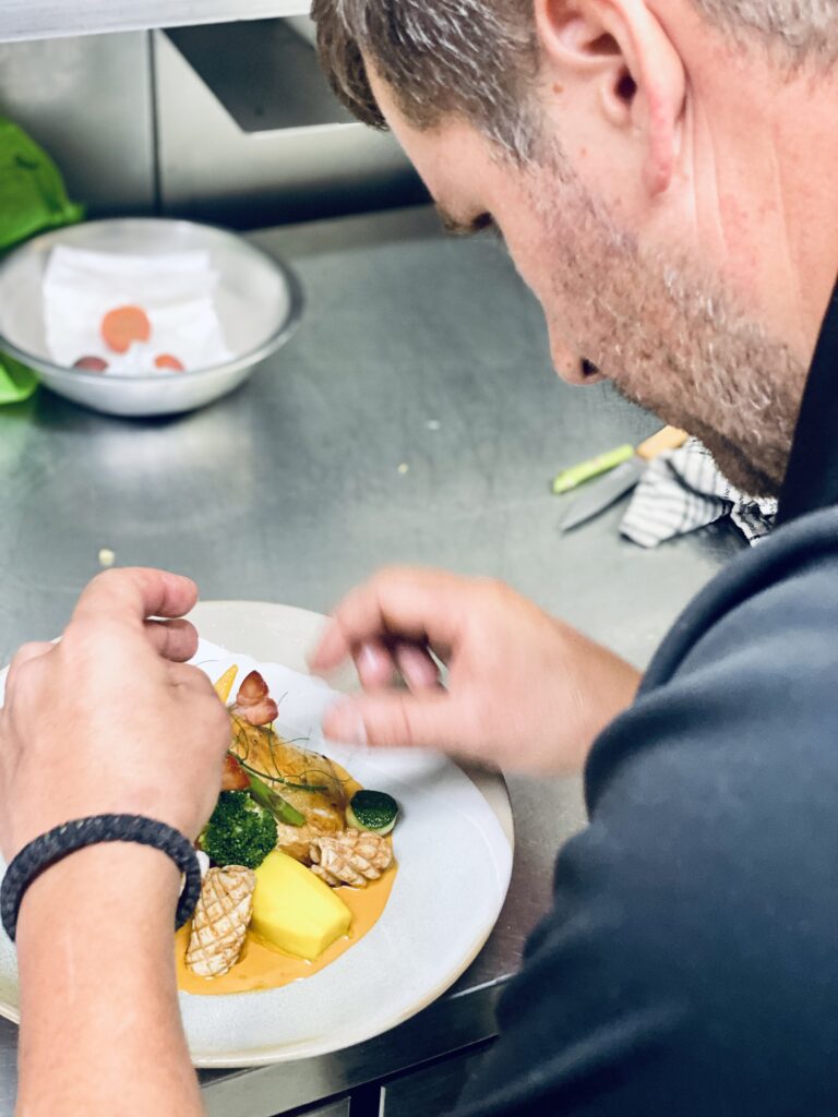 Chef plating food in kitchen